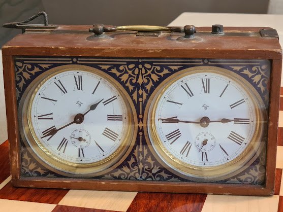 Philipp Haas & Söhne chess clock with Roman-numeral dials and decorated surrounds.