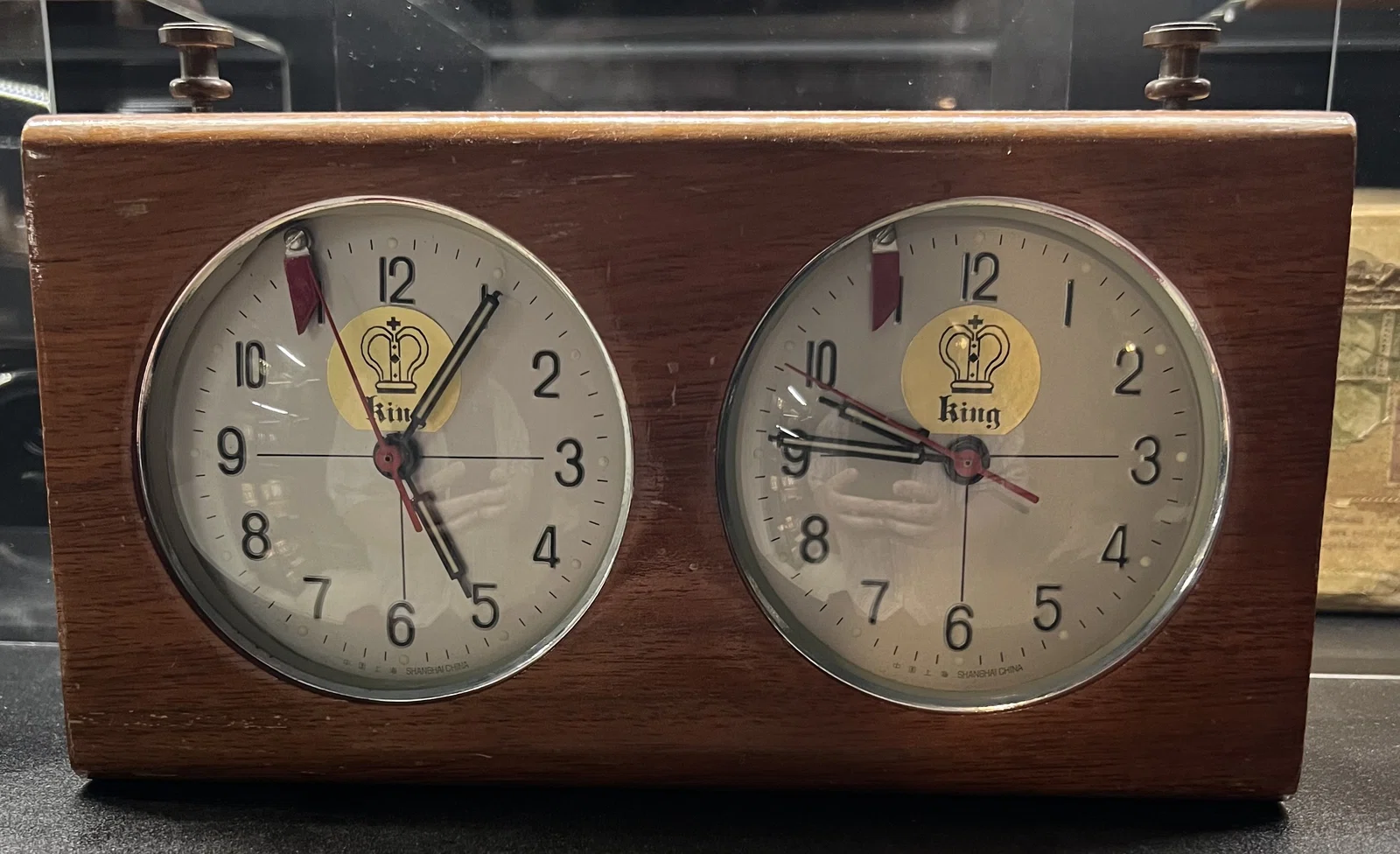 King of Aires Buenos Aires, Argentina Probably 1970s–1980s Tall wooden chess clock with widened base and internal lead weighting intended to improve stability.