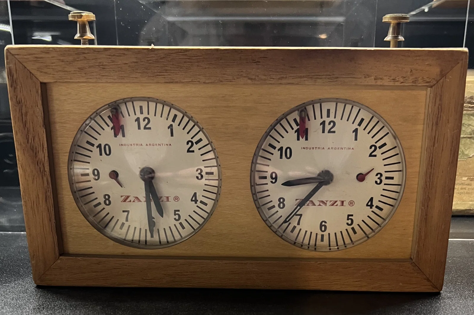 King of Aires Buenos Aires, Argentina Probably 1970s–1980s Tall wooden chess clock with widened base and internal lead weighting intended to improve stability.