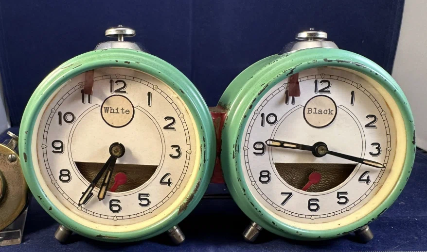 Unidentified chess clock built from two green alarm clocks marked White and Black